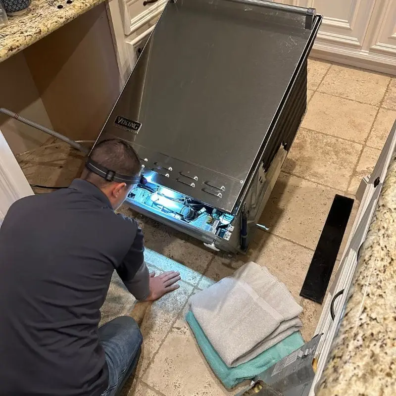 PowerOn Appliance Repair Service technician servicing Viking dishwasher in The Woodlands, TX.