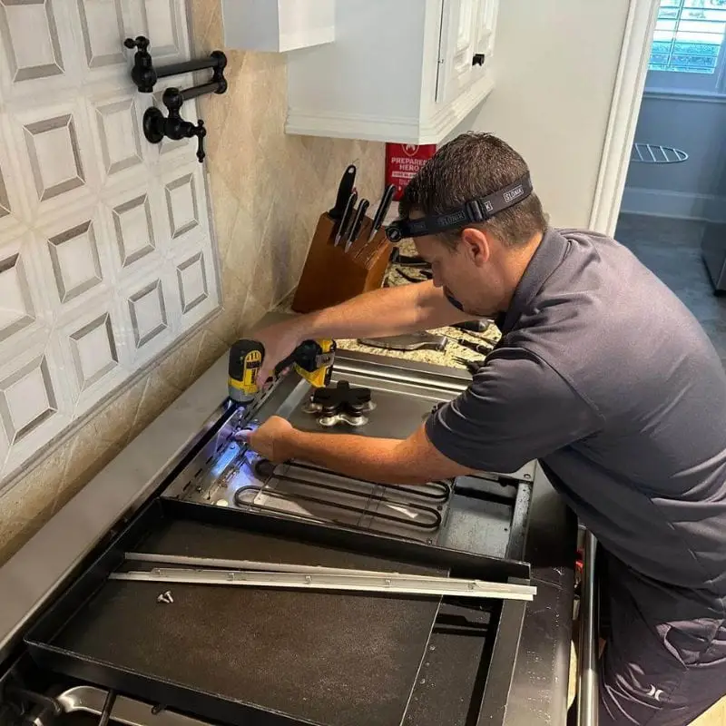 PowerOn Appliance Repair Service technician servicing Thermador range in The Woodlands, TX. Carlton Woods neighborhood