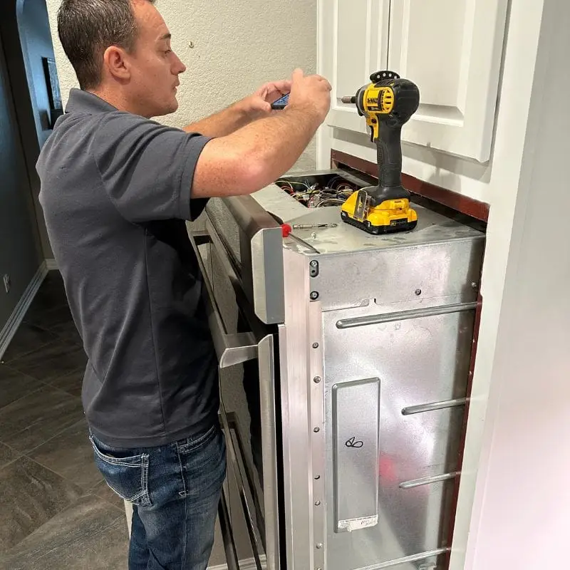 PowerOn Appliance Repair Service technician servicing Thermador double wall oven in Montgomery, TX.