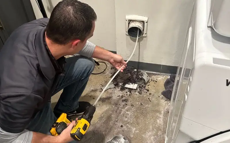 PowerOn Appliance Repair Service technician servicing dryer vent cleaning
