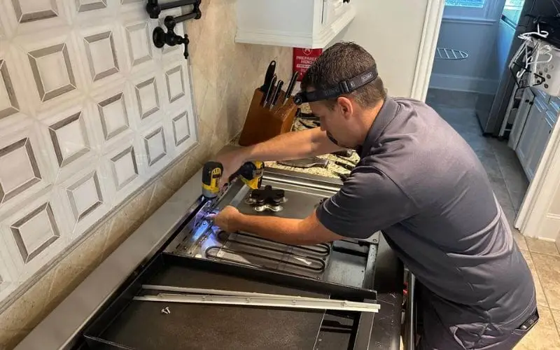 PowerOn Appliance Repair Service technician servicing Thermador range in The Woodlands, TX.