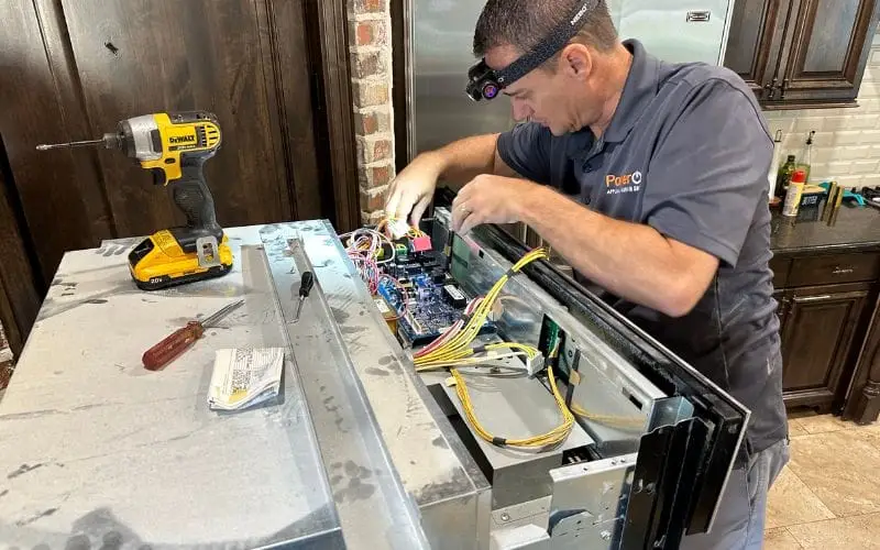 PowerOn Appliance Repair Service technician servicing Bosch wall oven in The Woodlands, TX.