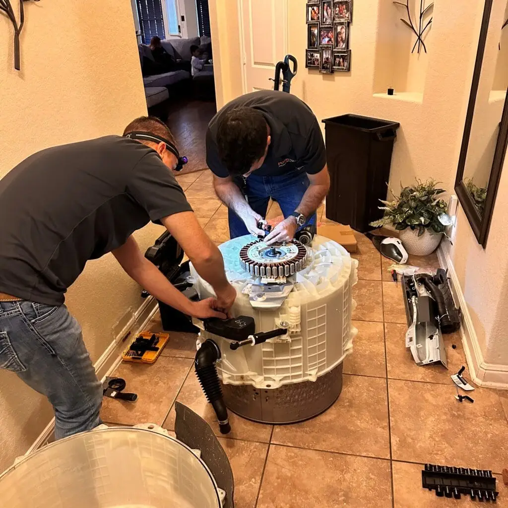 PowerOn Appliance Repair Service technicians working on washing drum in Spring, TX
