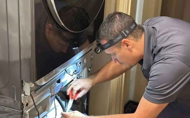 PowerOn Appliance Repair Service technician servicing LG front load washer (washer tower) in Spring, TX