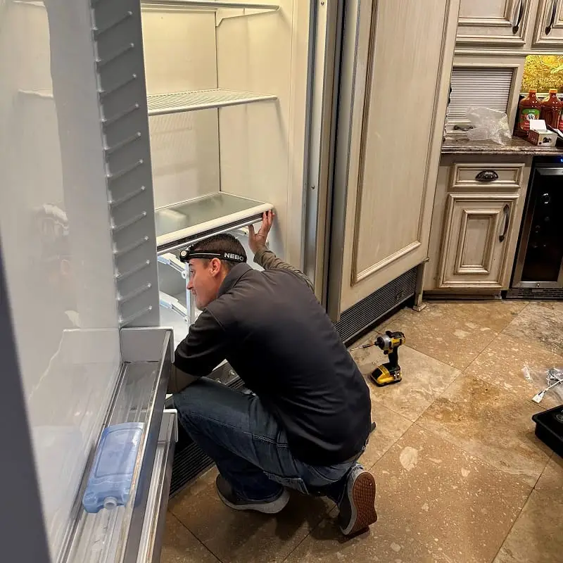 PowerOn Appliance Repair Service technician working on Sub-Zero freezer in Spring, TX