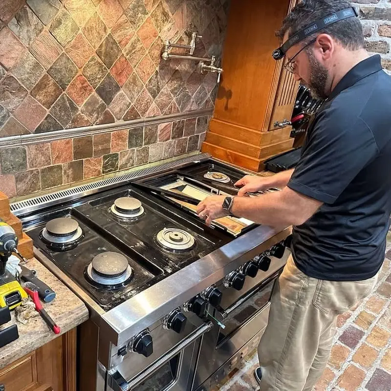PowerOn Appliance Repair Service technician working on Viking range in Spring, TX