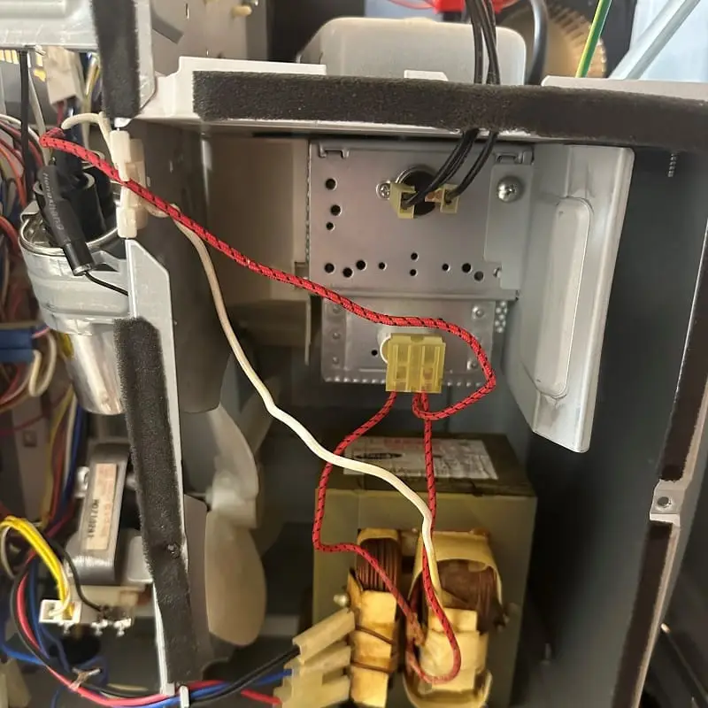 PowerOn Appliance Repair Service technician working on microwave