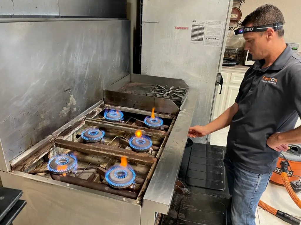 PowerOn Appliance Repair Service technician servicing DCS Range