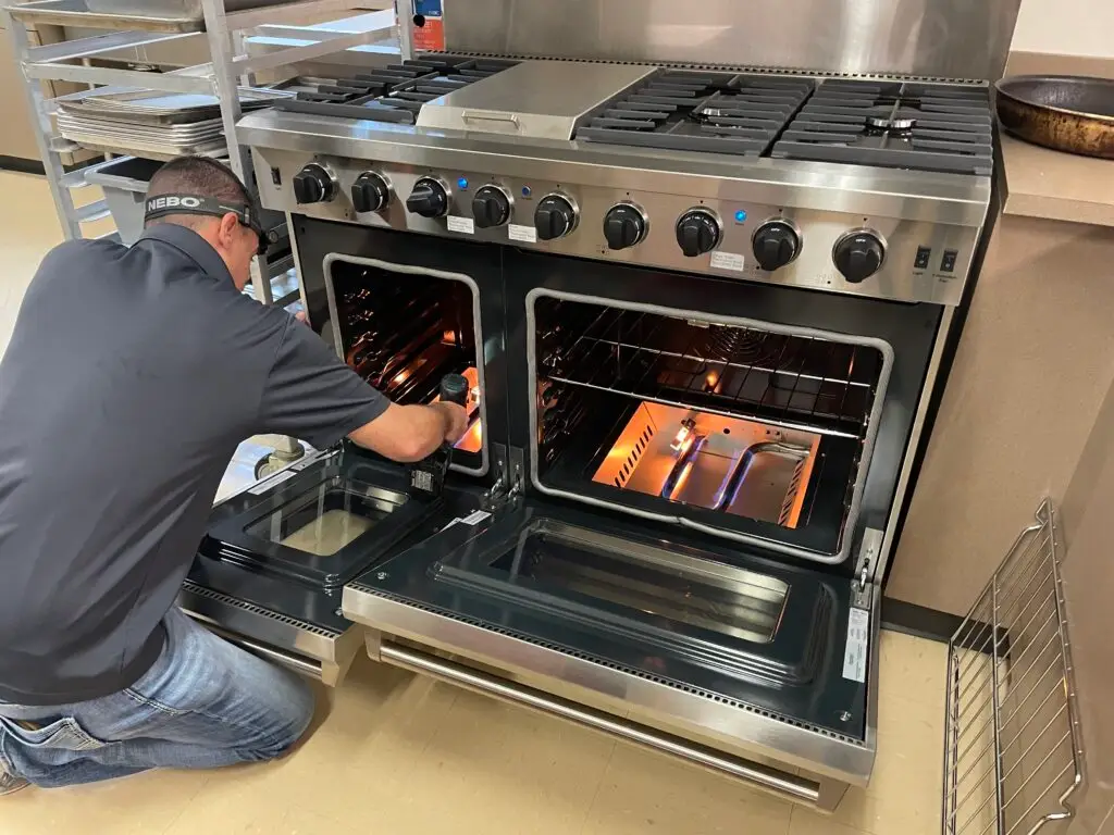 PowerOn Appliance Repair Service technician servicing Thor Gas Range in The Woodlands, TX.