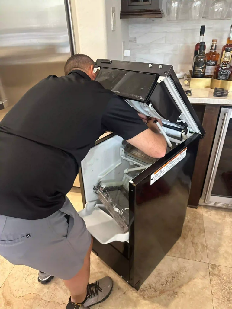 PowerOn Appliance Repair Service technician servicing KitchenAid ice machine in The Woodlands, TX.