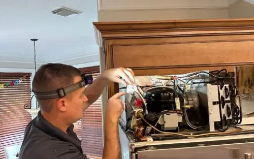 PowerOn Appliance Repair Service technician Servicing built in refrigerator compressor