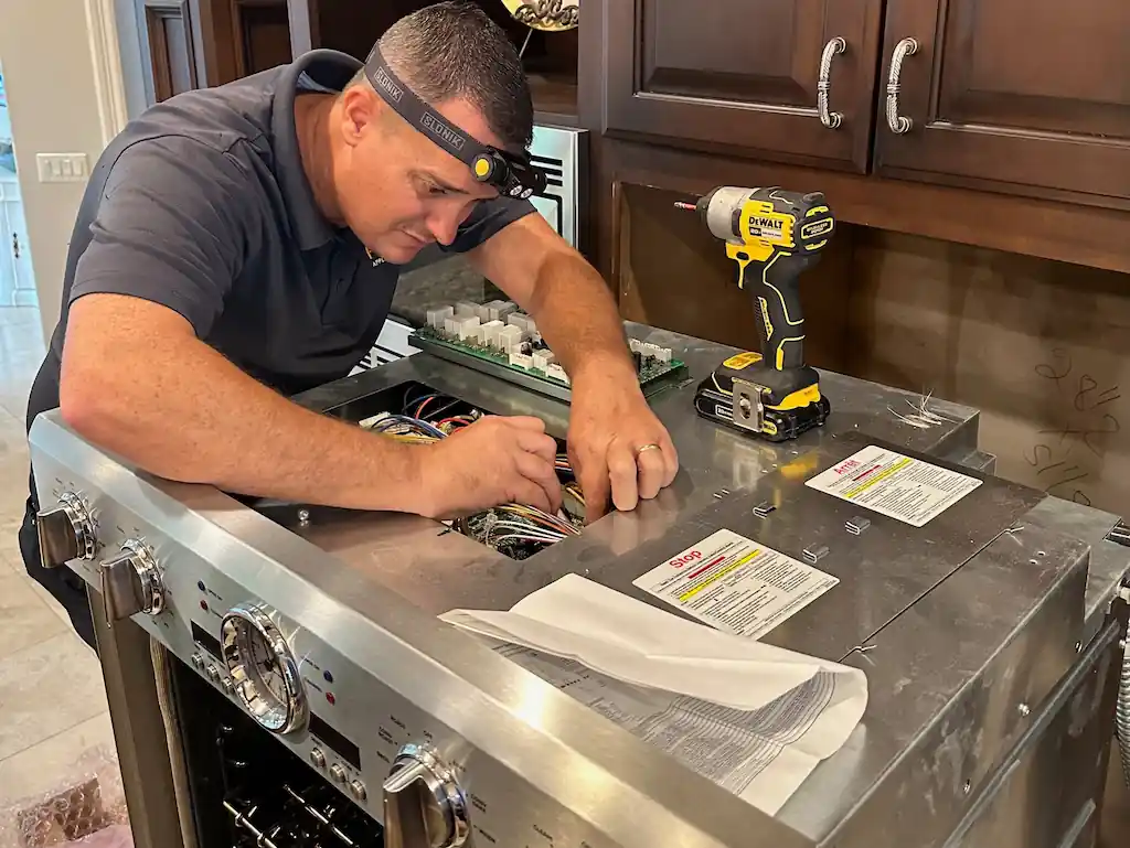 Technician repairing a Thermador oven fan that won't stop