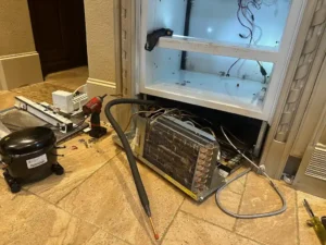 Built-in Sub-Zero freezer cabinet with the sealed system components removed for repair in a Woodlands home