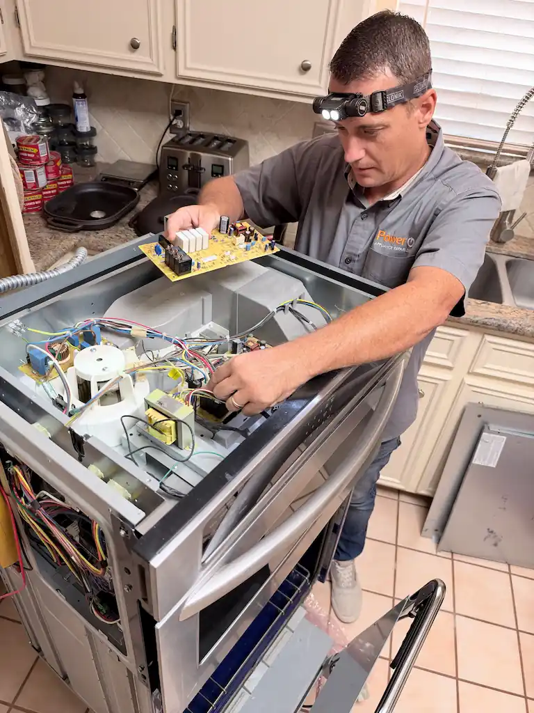 PowerOn technician replacing the microwave control board on a KitchenAid microwave oven combo with F6E8 error code