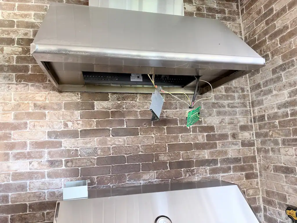 Dacor vent hood opened for diagnosis with control board exposed in an outdoor kitchen in Montgomery, TX