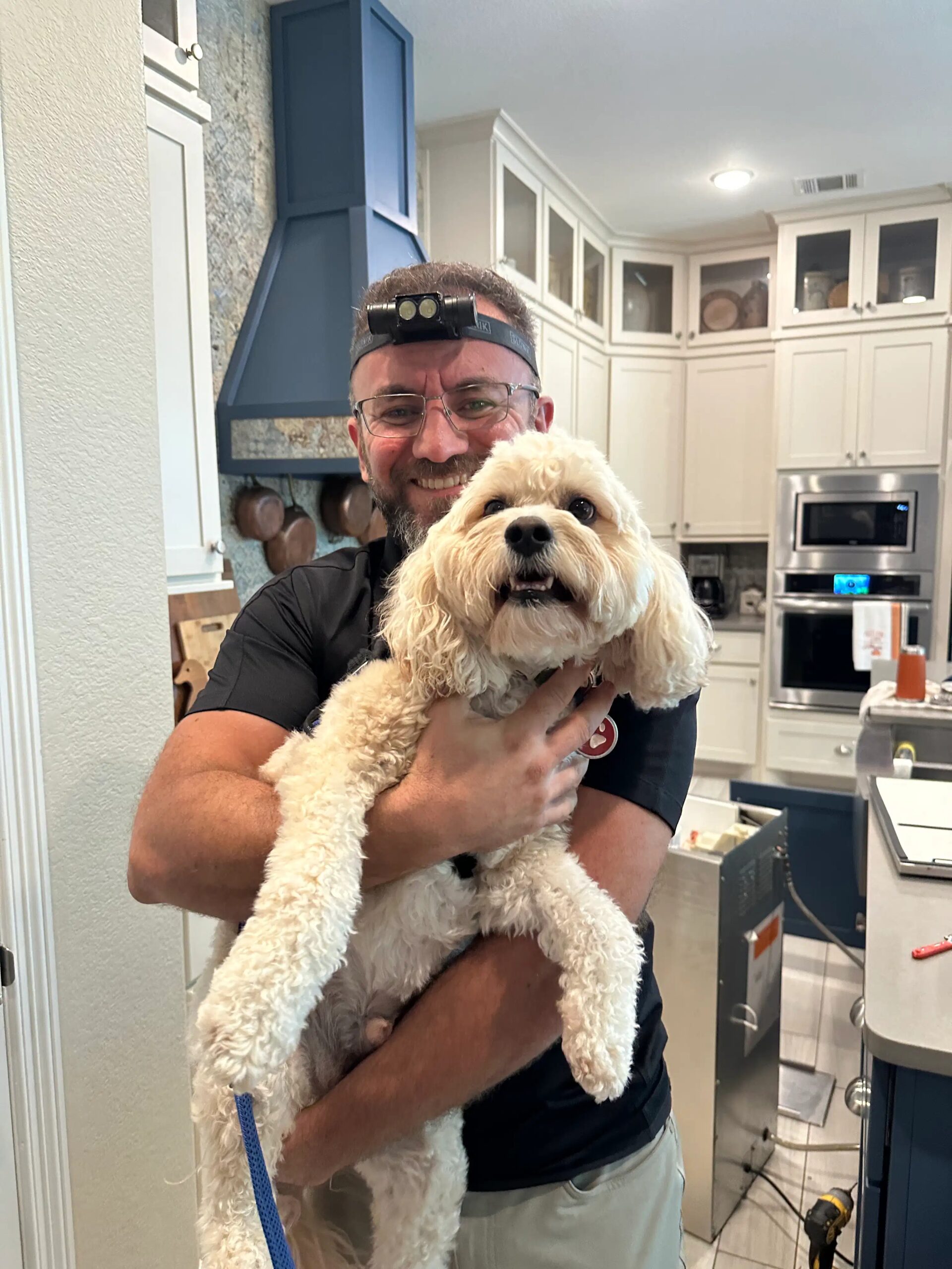 A friendly dog supervising a PowerOn appliance repair visit in Greater Houston